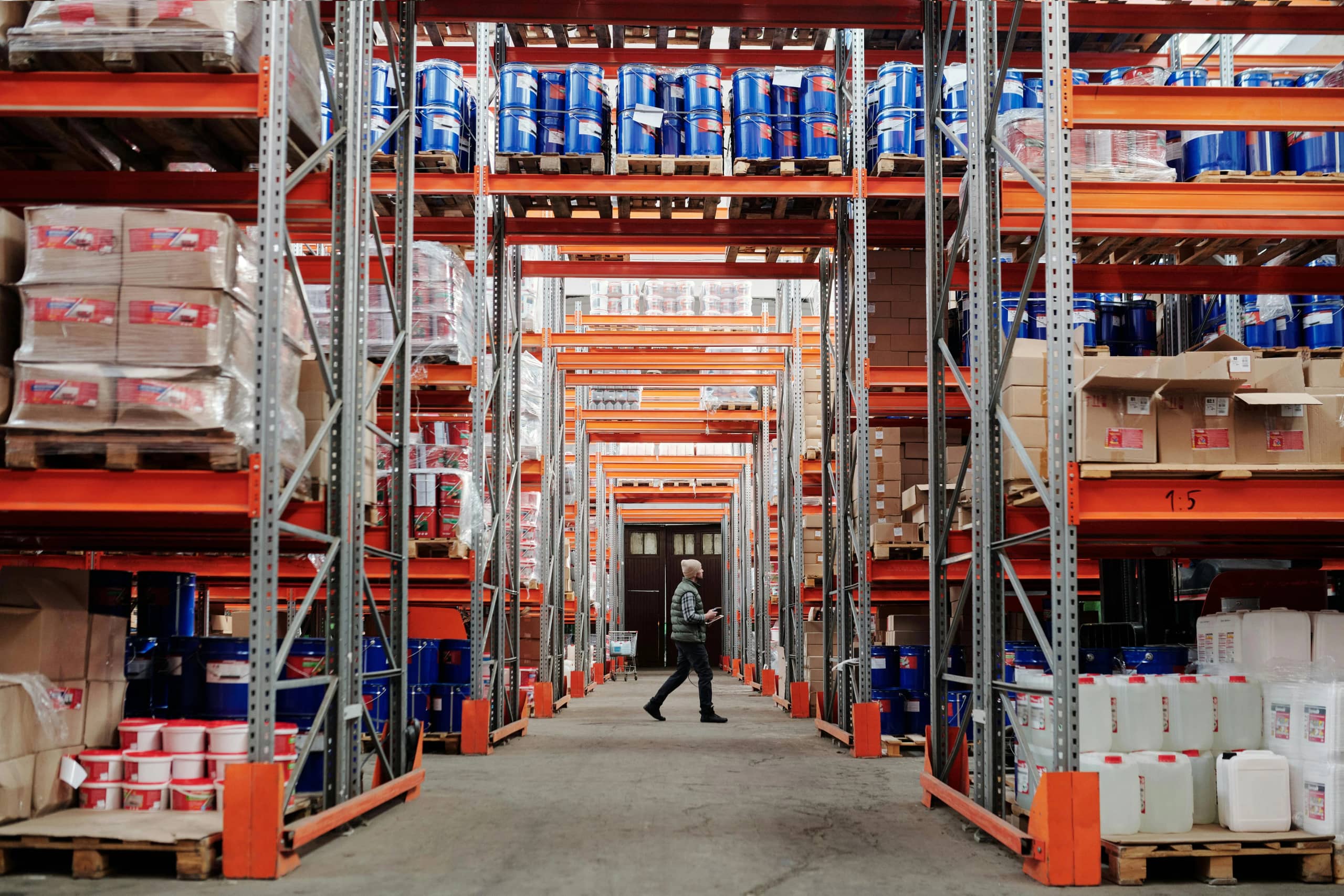 Warehouse aisles of palletised industrial supplies awaiting dispatch