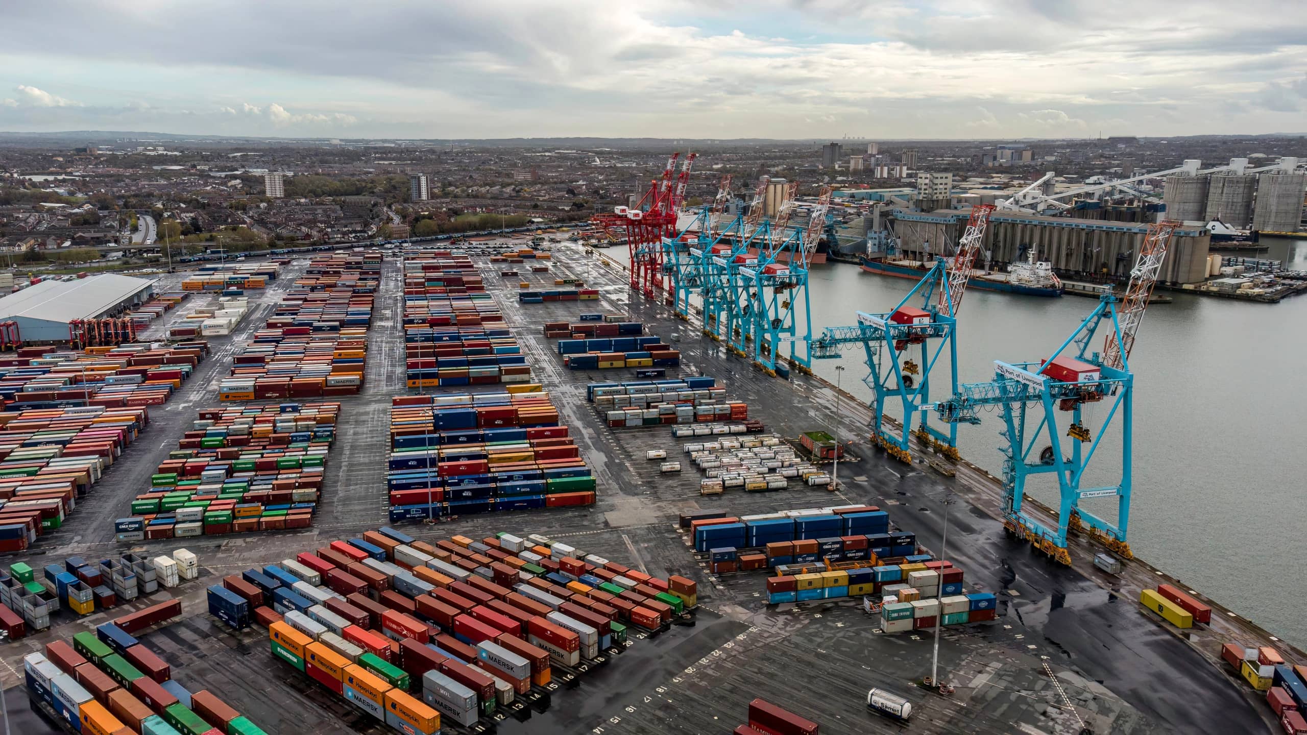 Aerial view of a container terminal, with ship-to-shore cranes along the quay